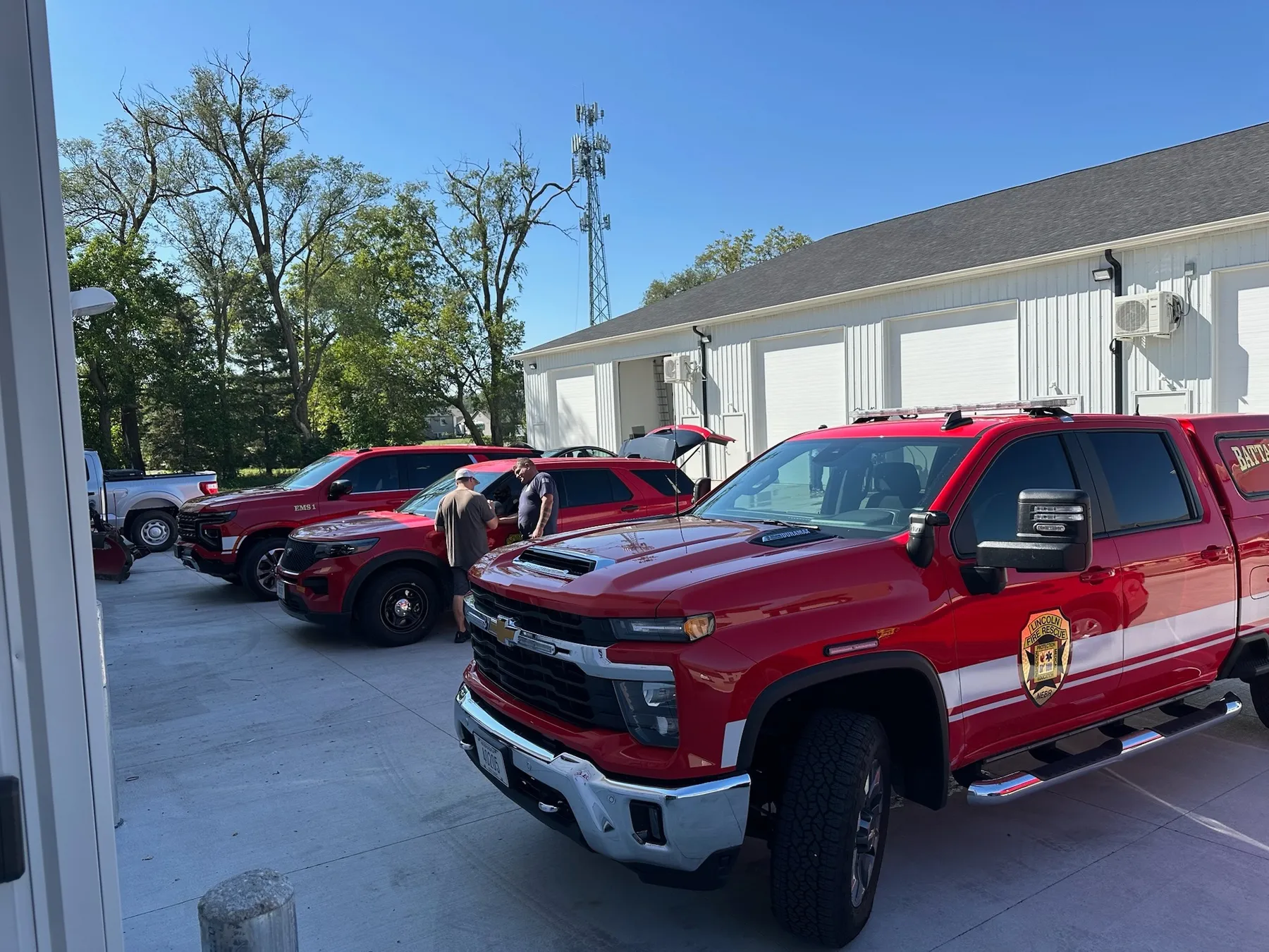 Fleet of red fire and rescue trucks outfitted by Elite Vehicle Outfitters