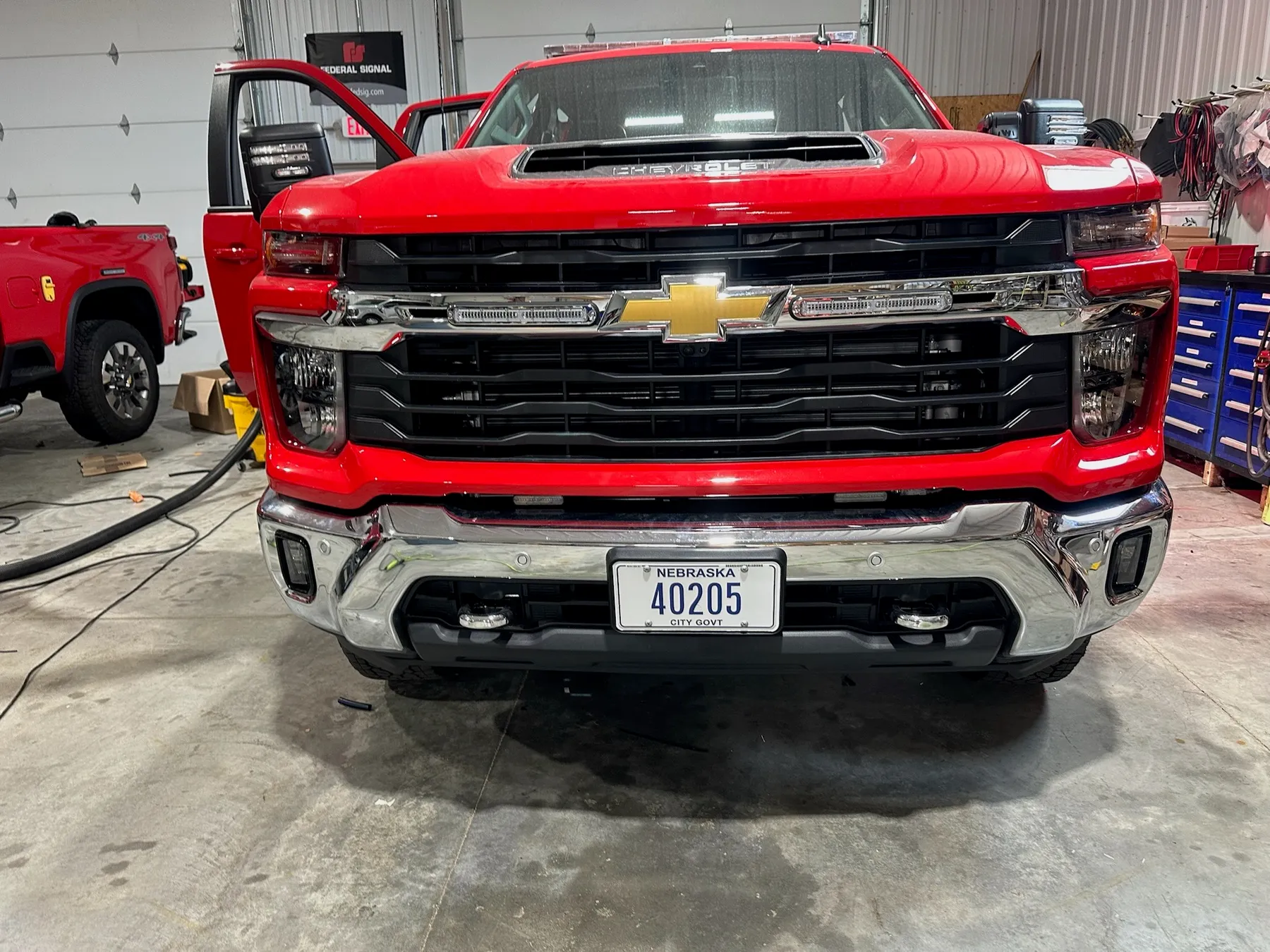 Red Chevrolet Silverado 2500 work truck built by Elite Vehicle Outfitters
