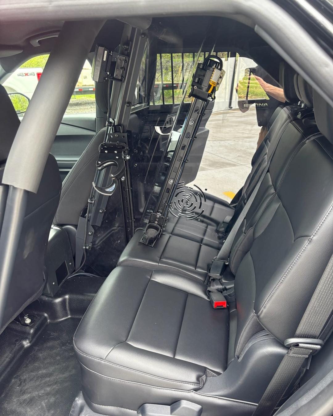 Rear police vehicle partition and prisoner transport setup installed by Elite Vehicle Outfitters